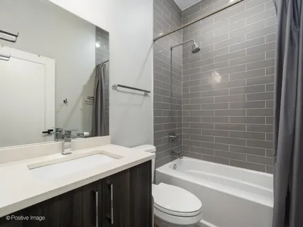 a bathroom with a sink a toilet and bathtub