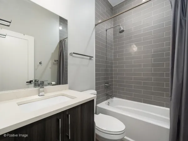 a bathroom with a sink a toilet and bathtub