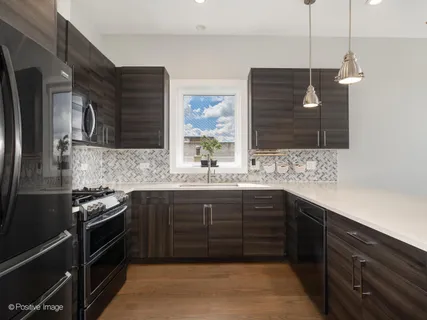 a kitchen with a sink and a stove top oven