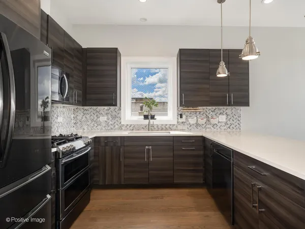 a kitchen with a sink and a stove top oven