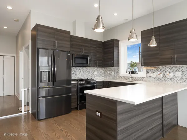 a kitchen with a sink stainless steel appliances and cabinets