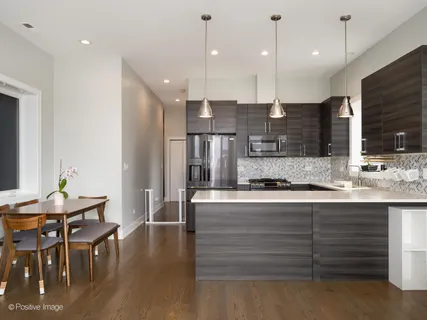a kitchen with stainless steel appliances kitchen island granite countertop a stove a sink and a refrigerator