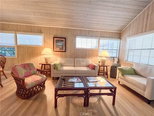 a living room with furniture a rug and a table