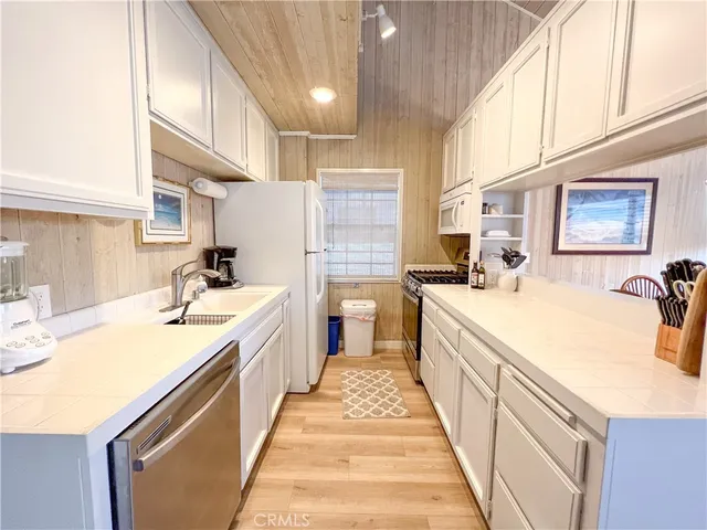 a large kitchen with stainless steel appliances lots of counter space and a sink