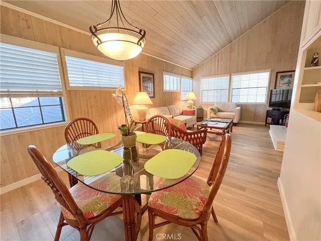 a dining room with furniture a window and wooden floor