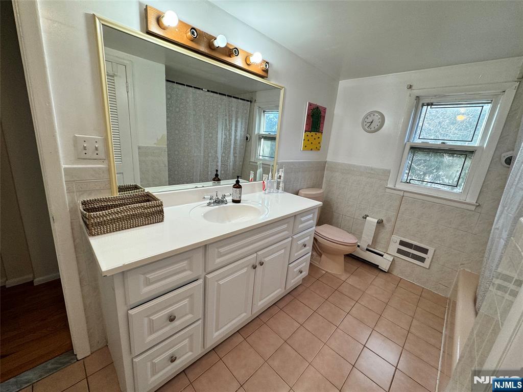 38 5th Street Closter, NJ 07624 - Photo 15 of 18 a bathroom with a double vanity sink mirror and toilet