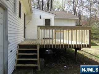 38 5th Street Closter, NJ 07624 - Photo 2 of 18 a front view of a house with a garden