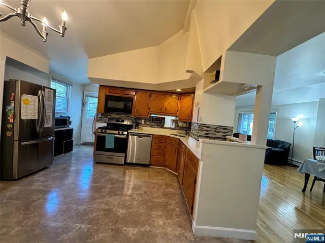 a kitchen with a sink stainless steel appliances and cabinets
