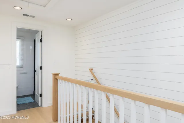 a view of a hallway to rooms