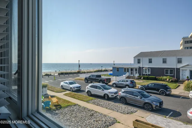 a city view with lot of cars and parked cars