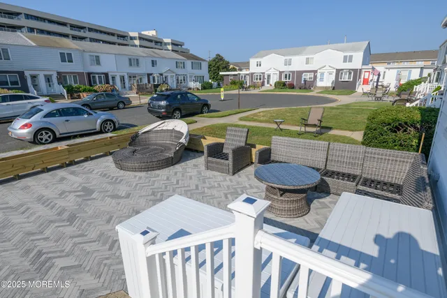 a view of a patio with table and chairs potted plants