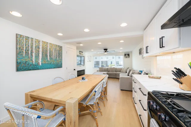 a kitchen that has a stove a table and chairs in it