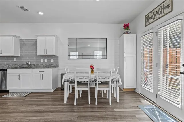 a view of a dining room with furniture and wooden floor
