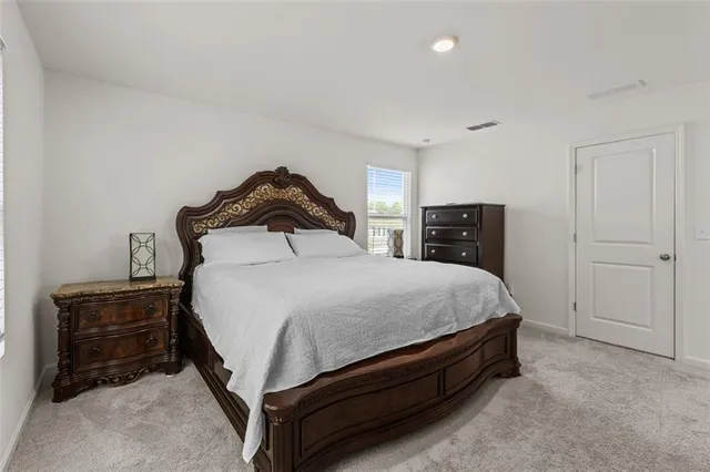 a bedroom with a bed and dresser