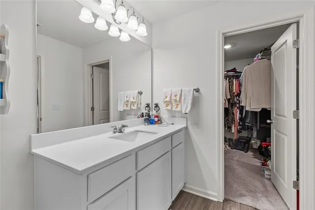 a bathroom with a sink a light fixture and a mirror