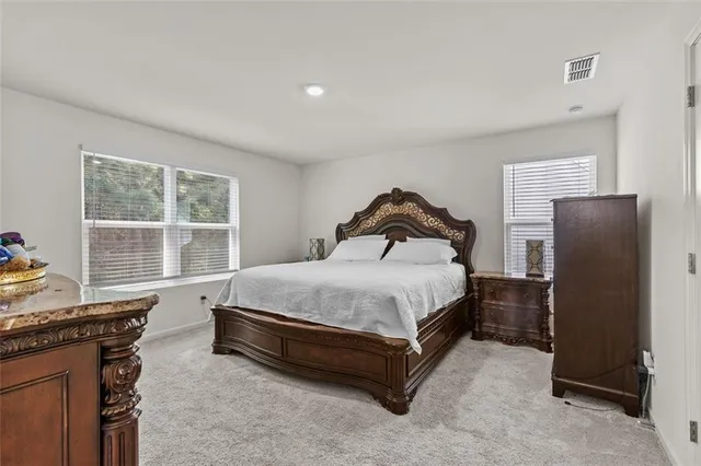 a bedroom with a bed dresser and a window