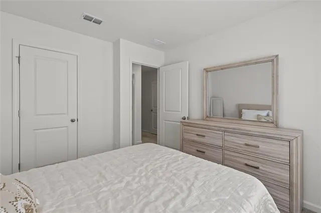 a bedroom with a bed and a mirror