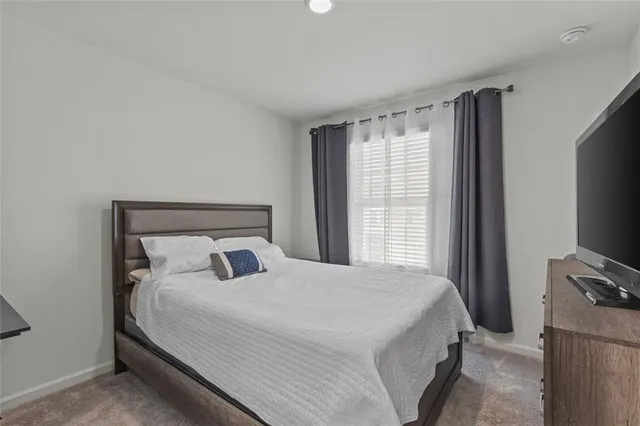 a bedroom with a bed and tv