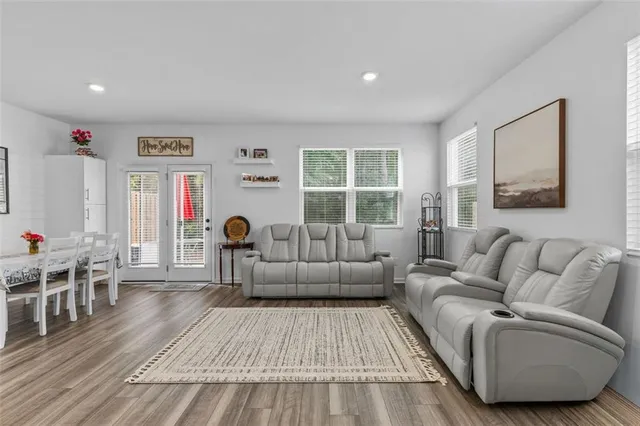 a living room with furniture and wooden floor