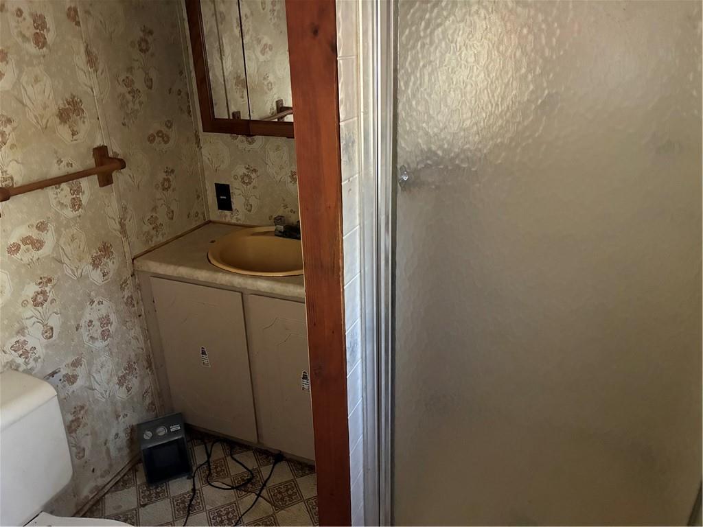 208 Manors Mill Road Dallas, GA 30157 - Photo 13 of 26 a bathroom with a sink and toilet