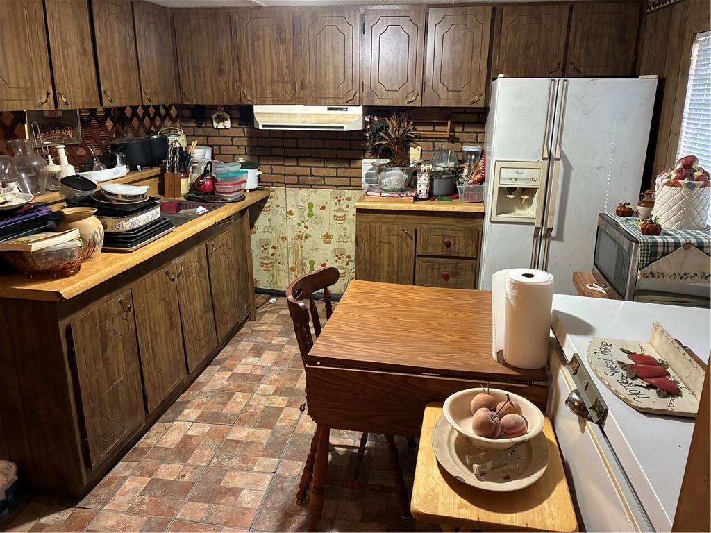 208 Manors Mill Road Dallas, GA 30157 - Photo 4 of 26 a kitchen with stainless steel appliances a sink a stove a refrigerator and cabinets