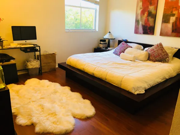 a bed sitting in a bedroom next to a window