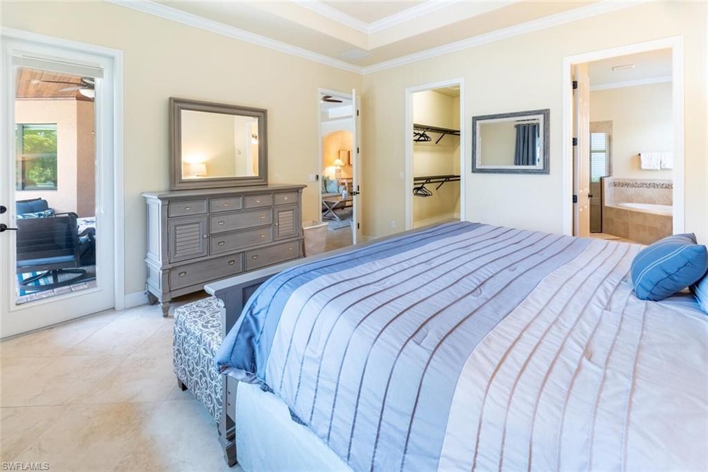 9372 Vercelli Court Naples, FL 34113 - Photo 20 of 50 Tiled bedroom featuring a spacious closet, a closet, connected bathroom, and ornamental molding
