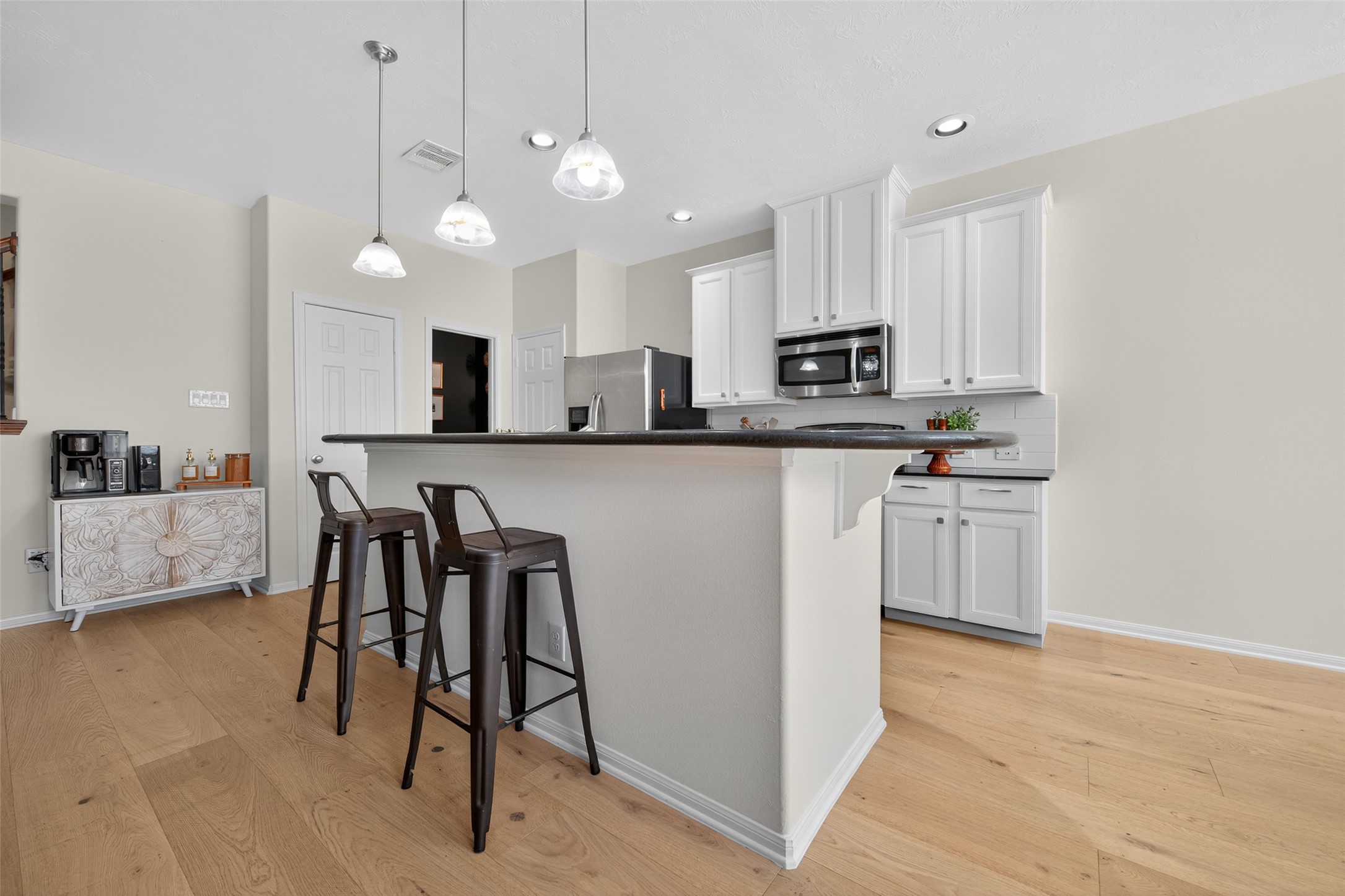 2806 Windy Thicket Lane Houston, TX 77082 - Photo 16 of 38 a kitchen with white cabinets and stainless steel appliances