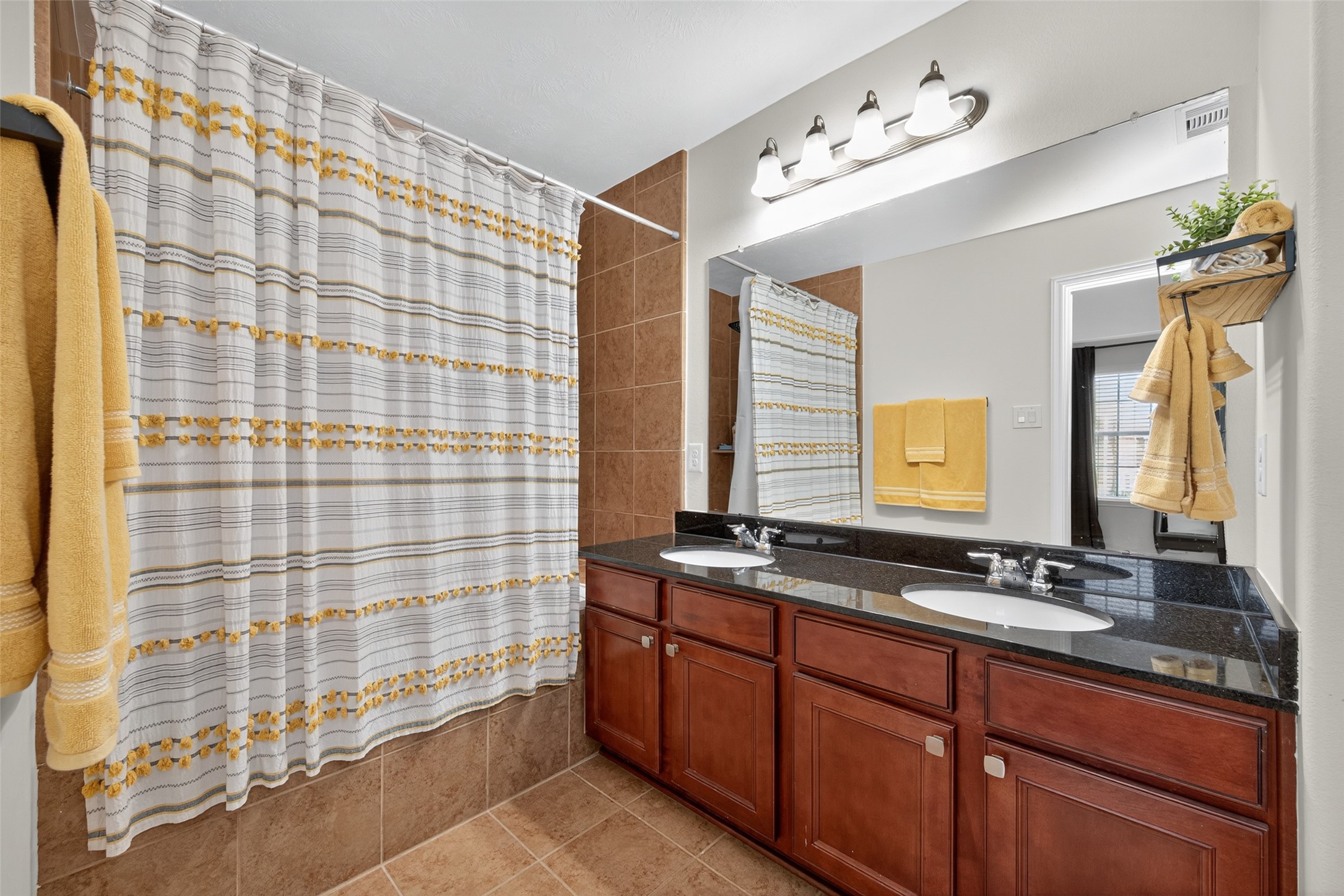 2806 Windy Thicket Lane Houston, TX 77082 - Photo 21 of 38 a bathroom with a sink a large mirror and a shower