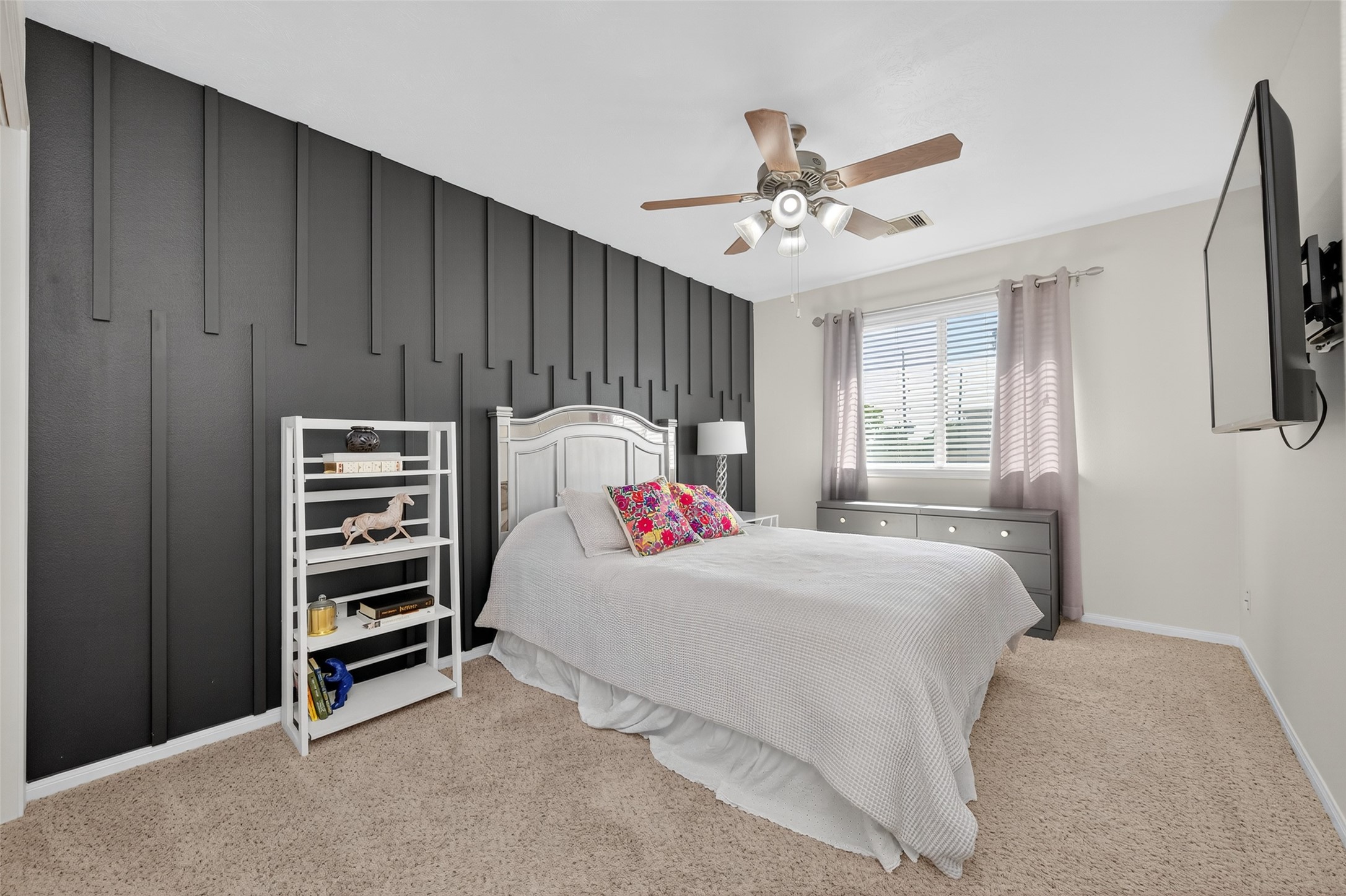 2806 Windy Thicket Lane Houston, TX 77082 - Photo 29 of 38 a bedroom with a bed and a chandelier