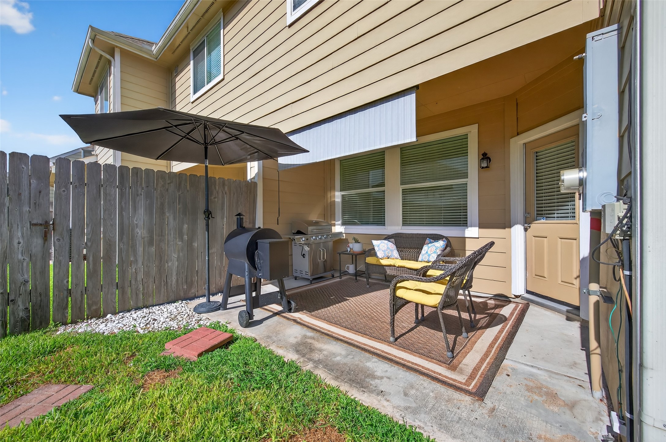 2806 Windy Thicket Lane Houston, TX 77082 - Photo 34 of 38 a view of a backyard with table and chairs under an umbrella with wooden fence