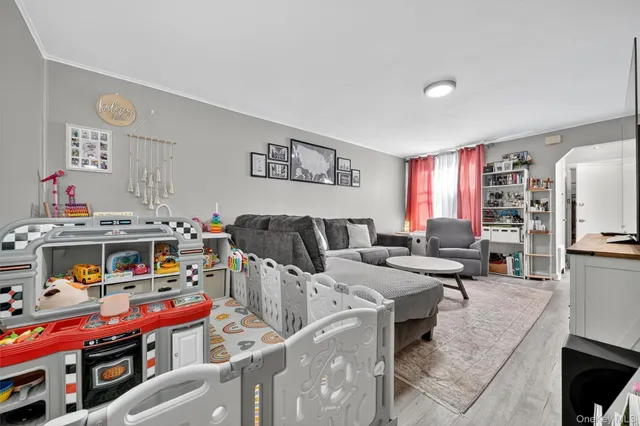 a living room with furniture a flat screen tv and a dining table