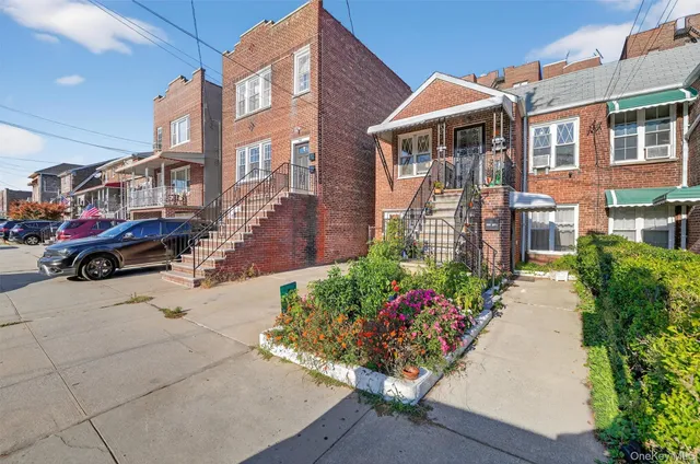 a front view of a residential houses with yard