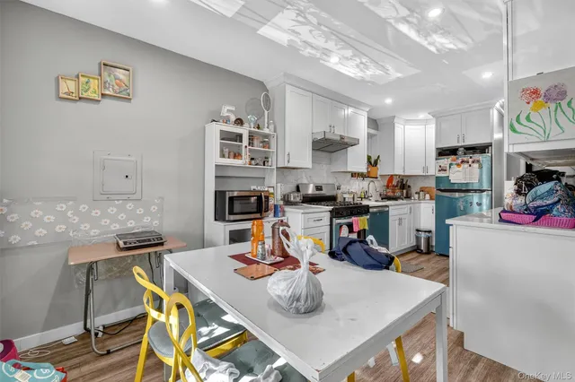 a kitchen with a table and chairs in it