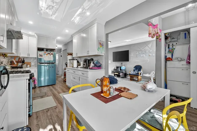 a kitchen with a sink dishwasher stove top oven and cabinets