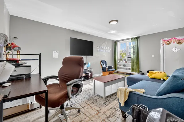 a bedroom with furniture and a flat screen tv