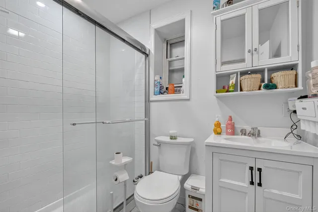 a white toilet sitting next to a bathroom sink