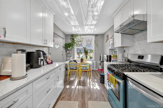 a kitchen with stainless steel appliances granite countertop a sink stove and cabinets