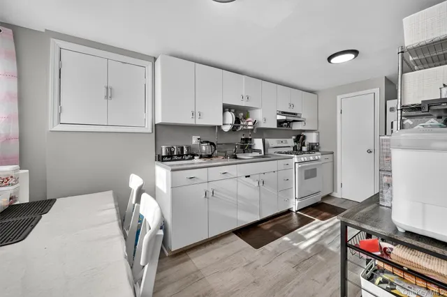 a kitchen with stainless steel appliances a stove a sink cabinets and a refrigerator