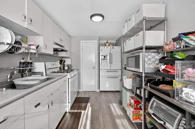 a kitchen with stainless steel appliances a stove a sink and cabinets