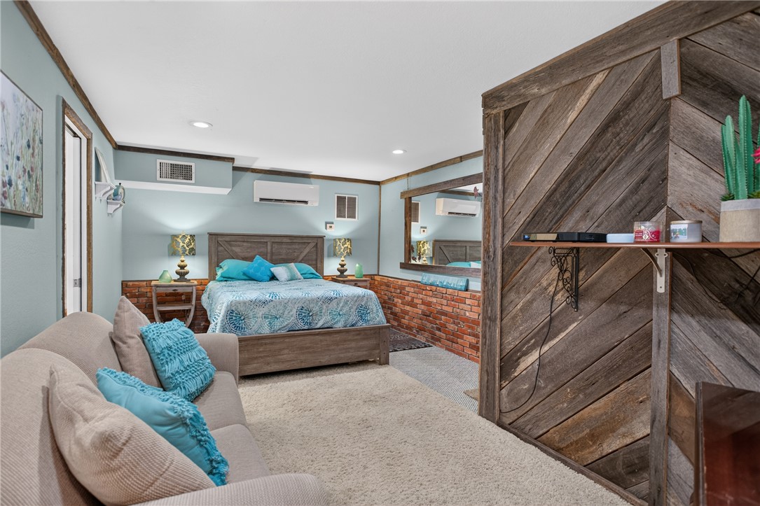 351 River Road Westminster, SC 29693 - Photo 35 of 50 An inviting private bedroom next to garage features warm wood tones, exposed brick accents, and plush carpeting for ultimate comfort.