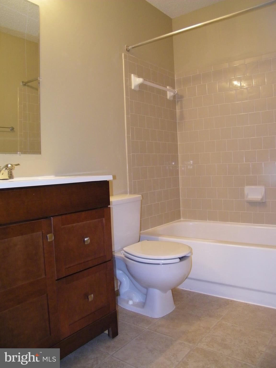 20963 Timber Ridge Terrace, Unit 202 Ashburn, VA 20147 - Photo 12 of 22 a bathroom with a sink toilet and shower