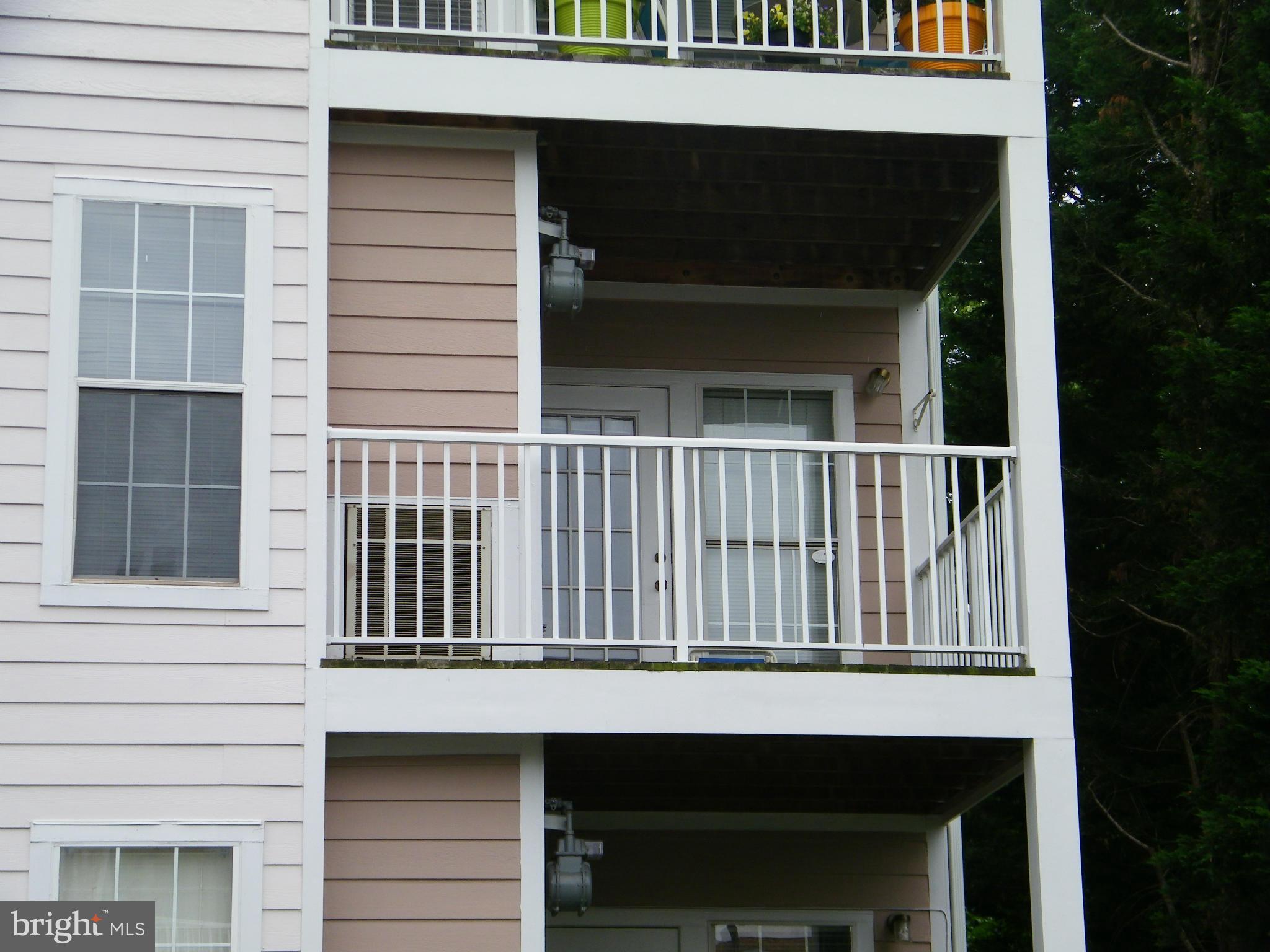 20963 Timber Ridge Terrace, Unit 202 Ashburn, VA 20147 - Photo 16 of 22 a view of a house with a porch