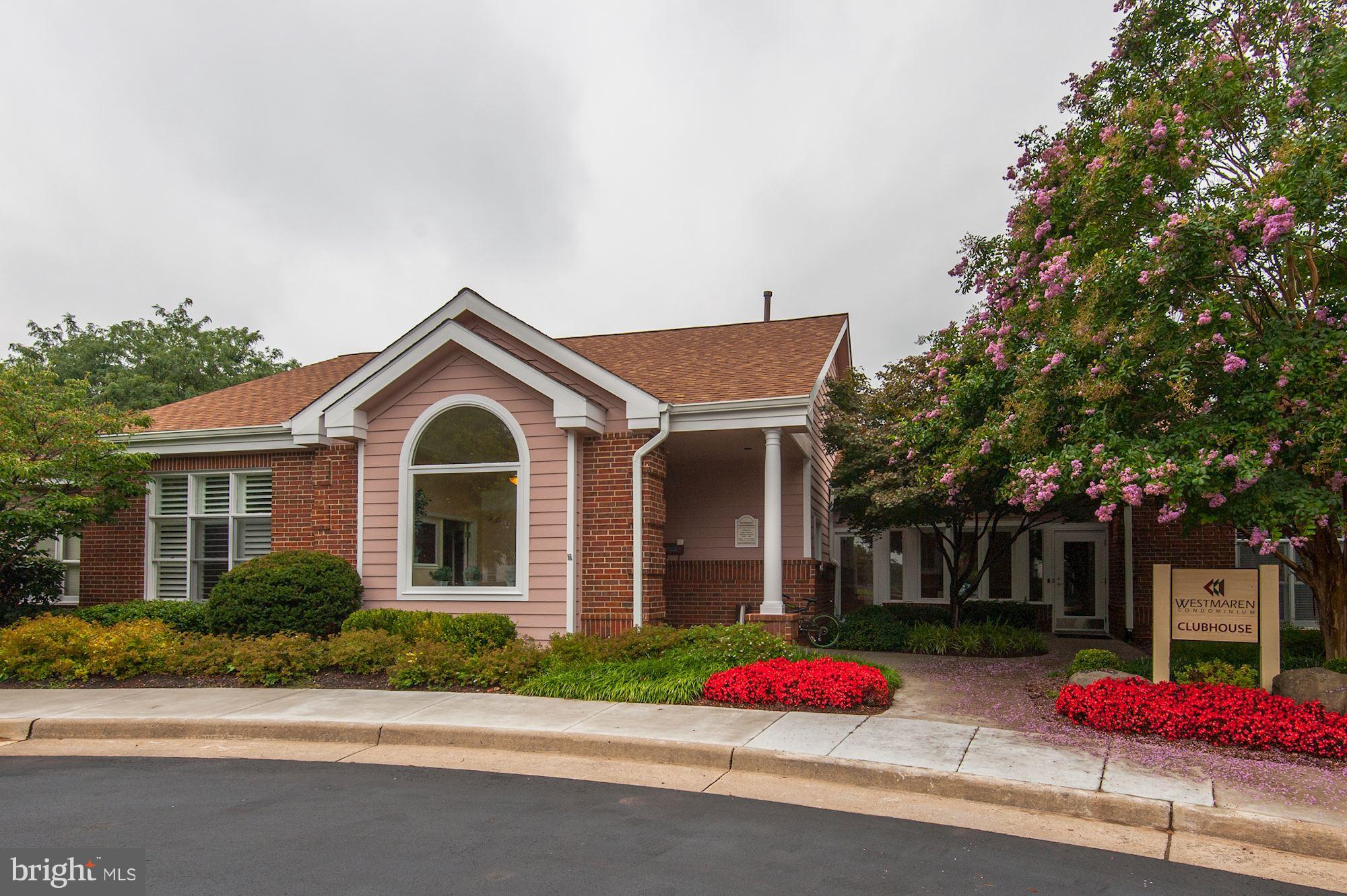 20963 Timber Ridge Terrace, Unit 202 Ashburn, VA 20147 - Photo 17 of 22 a front view of a house with yard
