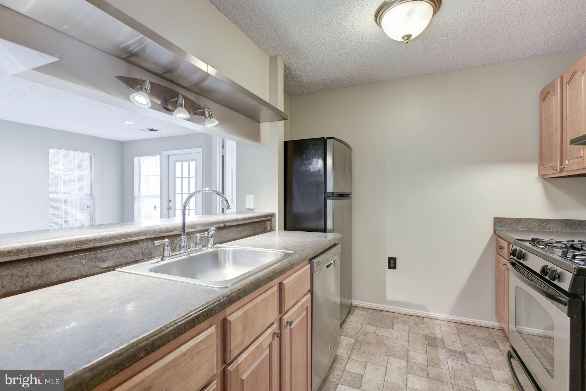 20963 Timber Ridge Terrace, Unit 202 Ashburn, VA 20147 - Photo 4 of 22 a bathroom with a sink double vanity and a mirror