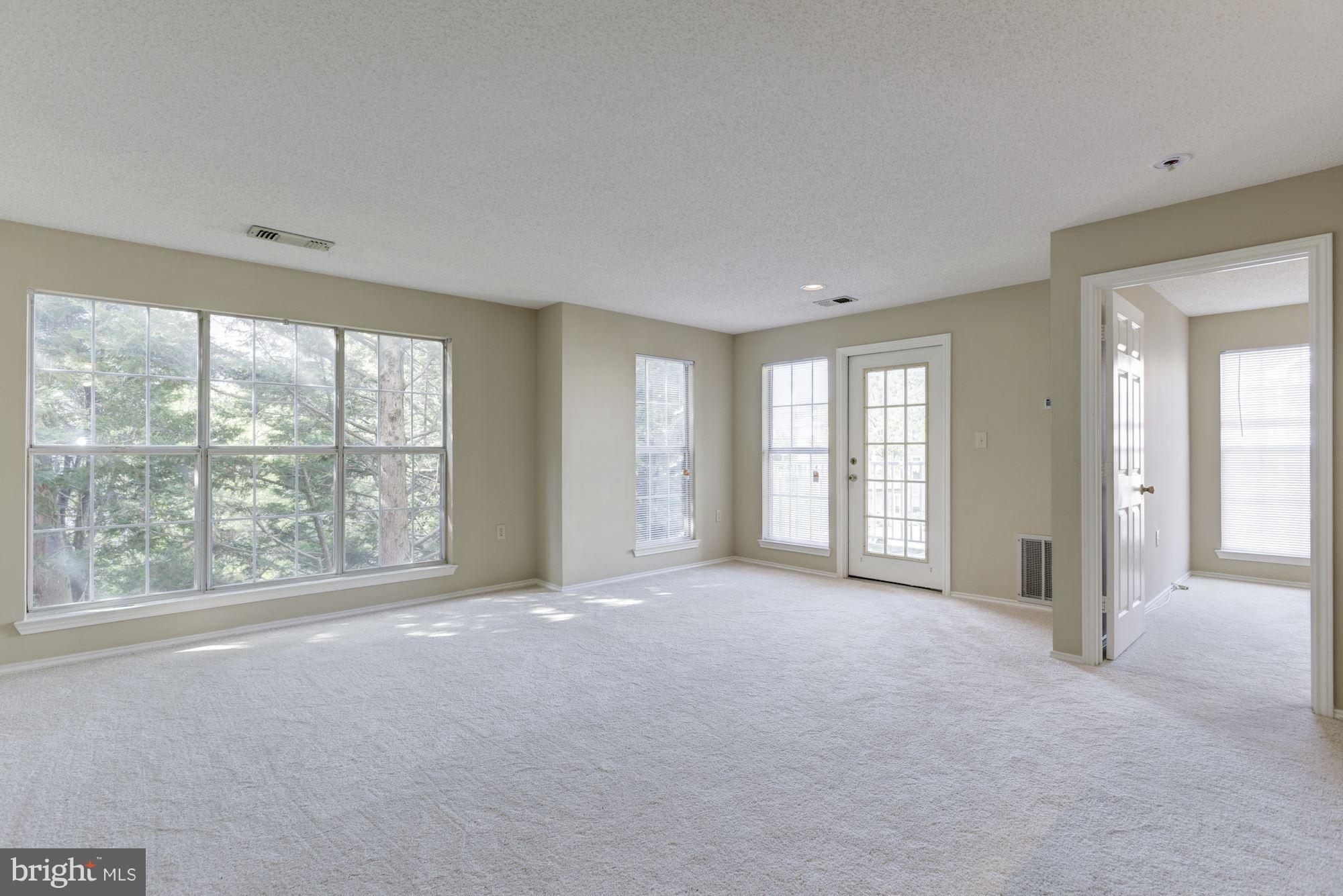 20963 Timber Ridge Terrace, Unit 202 Ashburn, VA 20147 - Photo 8 of 22 a view of an empty room with a window