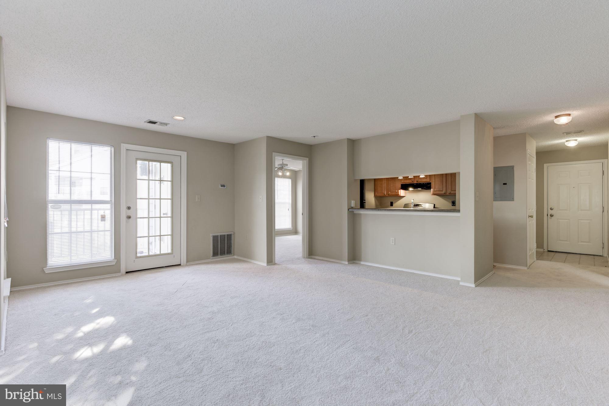 20963 Timber Ridge Terrace, Unit 202 Ashburn, VA 20147 - Photo 9 of 22 a view of an empty room with a window