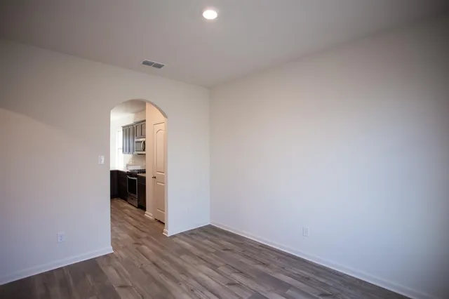 a view of a room with wooden floor and white walls