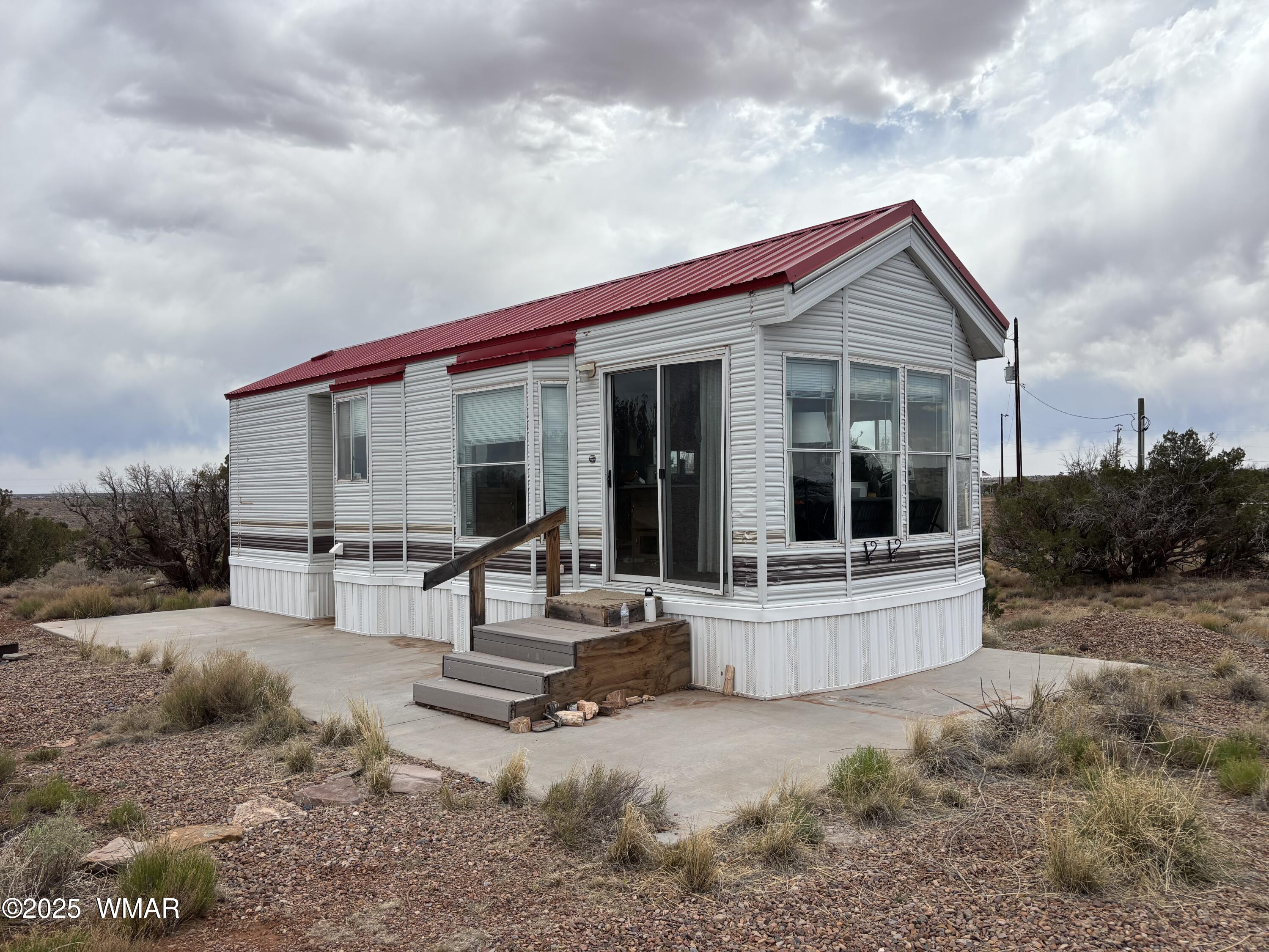a view of house with backyard and sitting area