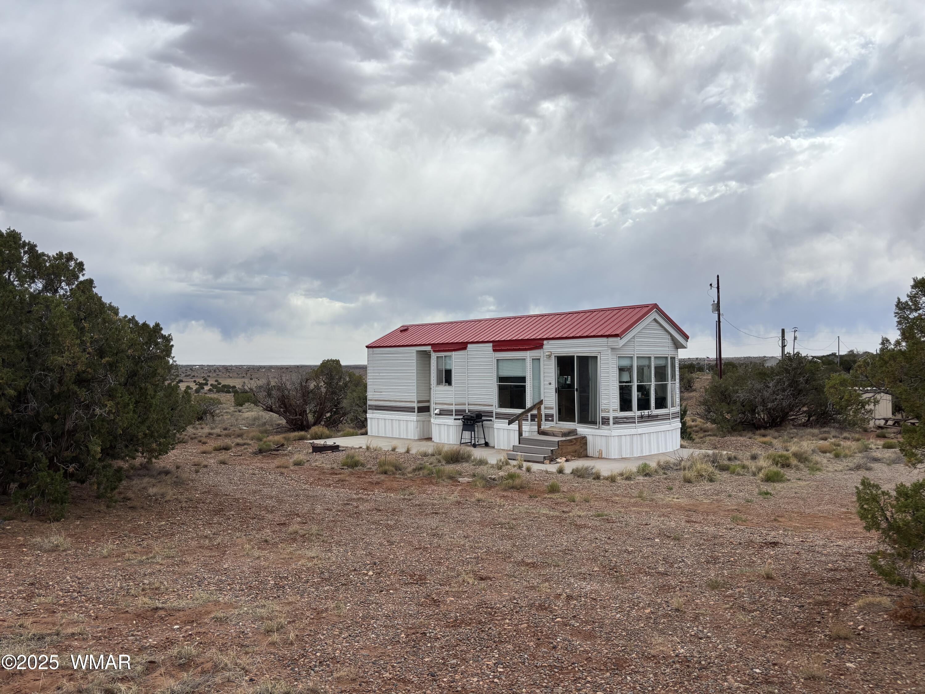 5233 Concho Ocho Road Snowflake, AZ 85937 - Photo 4 of 19 a front view of a house with table and chairs